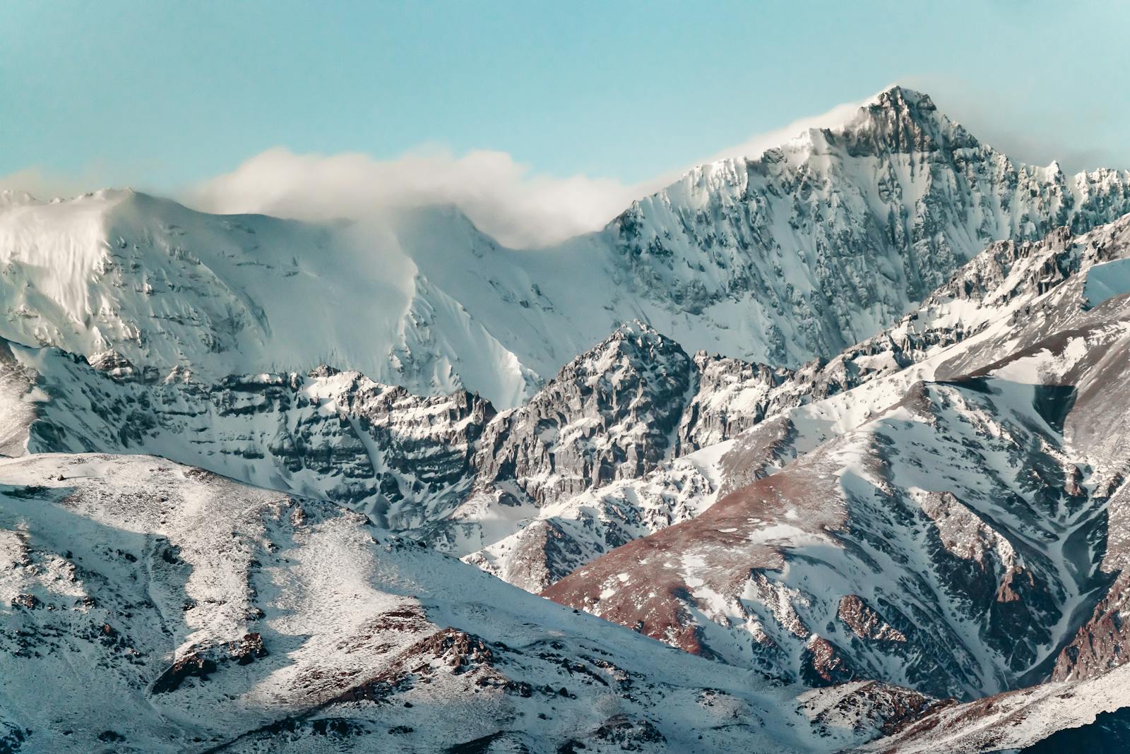 Breathtaking view of snow-covered Andes mountains near Santiago, Chile, under a clear blue sky.